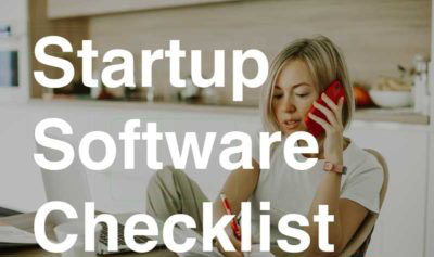 Women on phone at kitchen table - software startup checklist