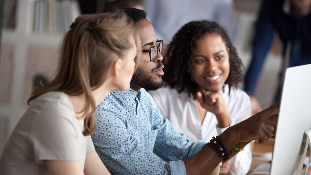 hr team looks at computer screen together