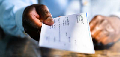 man with paycheck - B2B Suggest logo