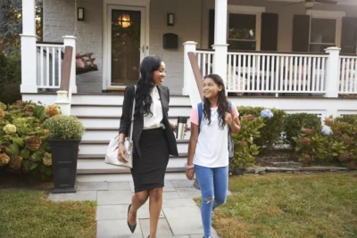 mom bringing her child to bus stop on way to work